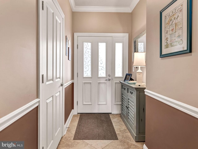 entrance foyer featuring crown molding and light tile patterned flooring