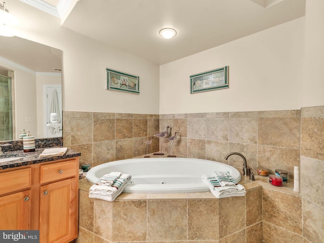 bathroom featuring ornamental molding, a relaxing tiled tub, and vanity