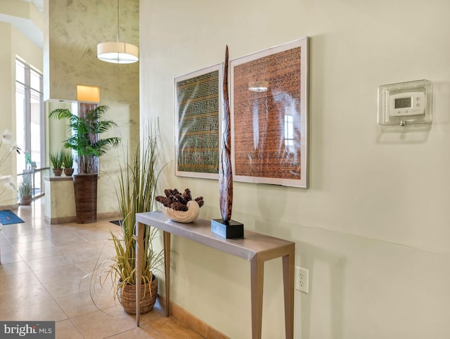 hall with light tile patterned floors