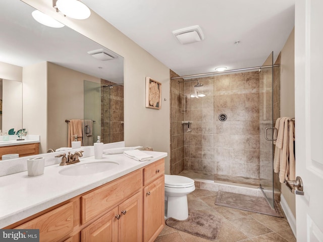 bathroom with toilet, walk in shower, and vanity