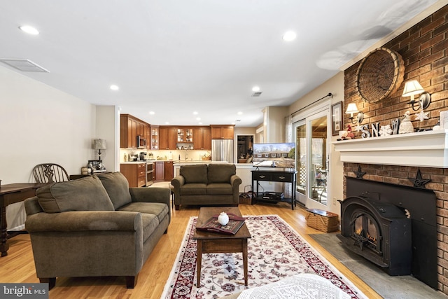 living room featuring sink and light hardwood / wood-style floors