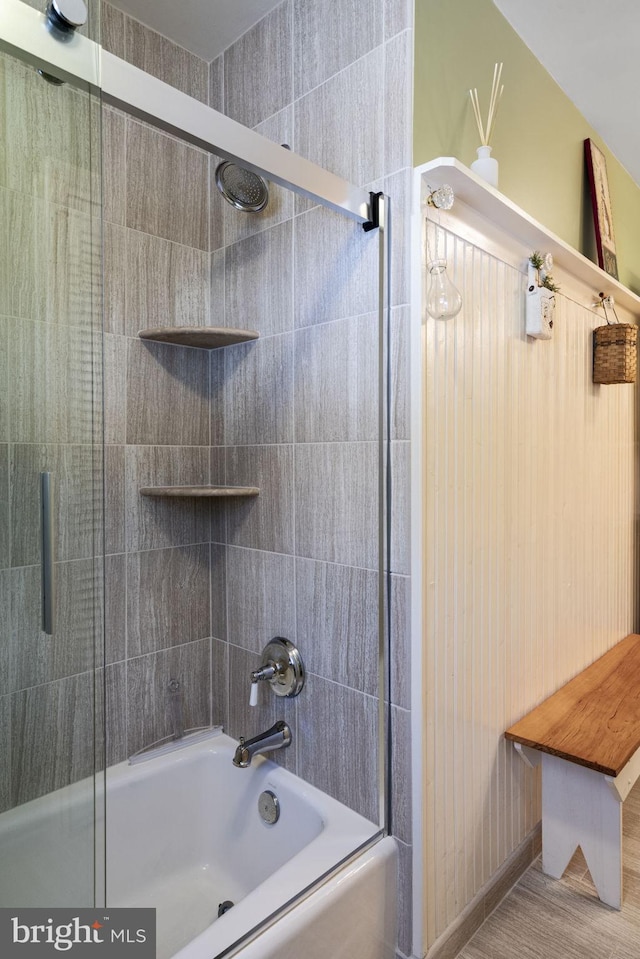 bathroom with shower / bath combination with glass door and hardwood / wood-style floors