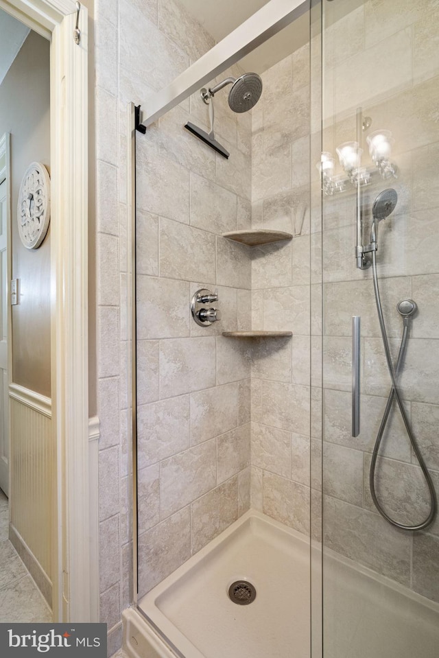 bathroom featuring a shower with door