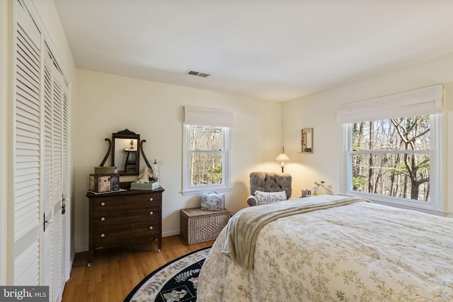 bedroom with hardwood / wood-style flooring and a closet