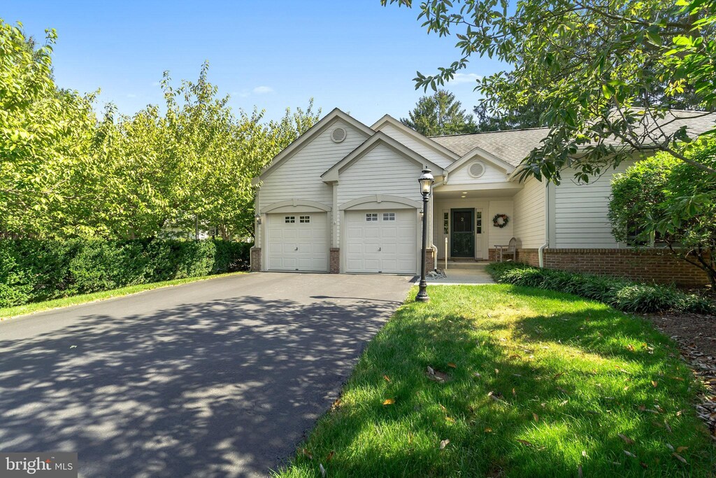 ranch-style home with a front yard and a garage