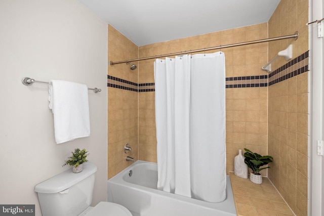 bathroom with toilet and shower / tub combo with curtain