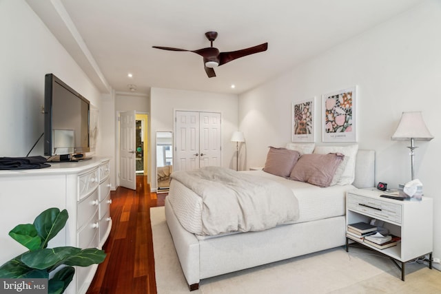 bedroom featuring ceiling fan, wood-type flooring, and a closet