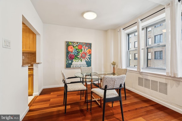 dining space with dark hardwood / wood-style flooring