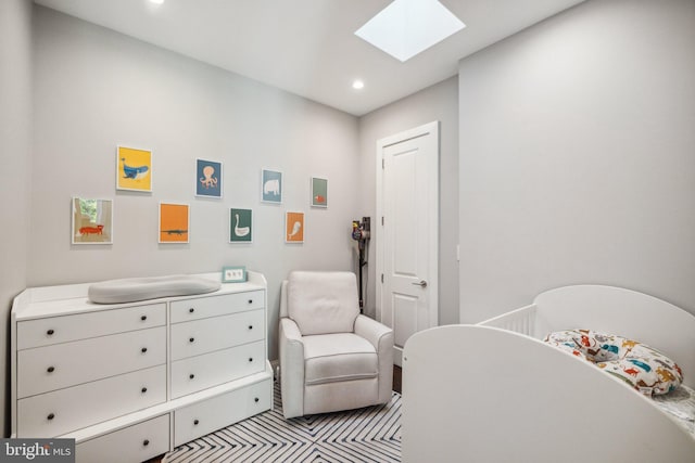 bedroom with a crib and a skylight