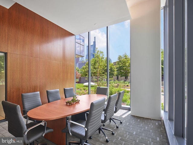 interior space with floor to ceiling windows and wooden walls