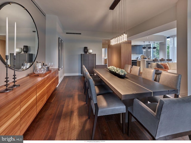 dining space featuring dark wood-type flooring