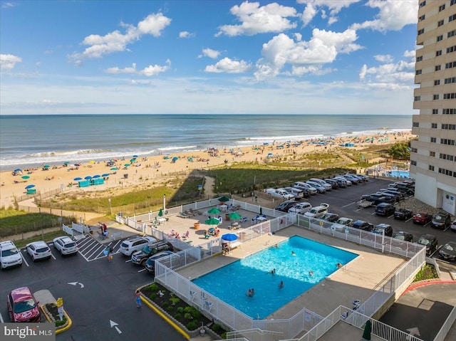 birds eye view of property with a view of the beach and a water view