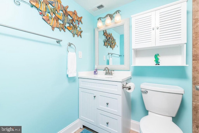 bathroom with toilet and vanity