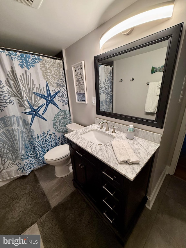 bathroom featuring toilet and vanity