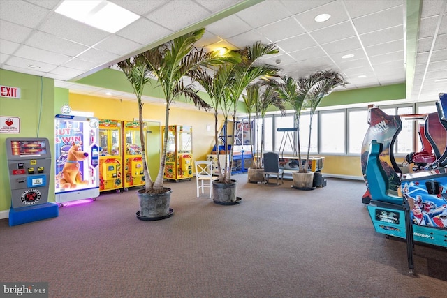 exercise room with a paneled ceiling and carpet flooring