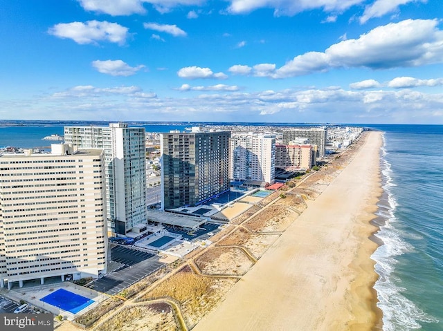 birds eye view of property featuring a view of the beach and a water view