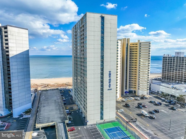 exterior space featuring a water view and a beach view