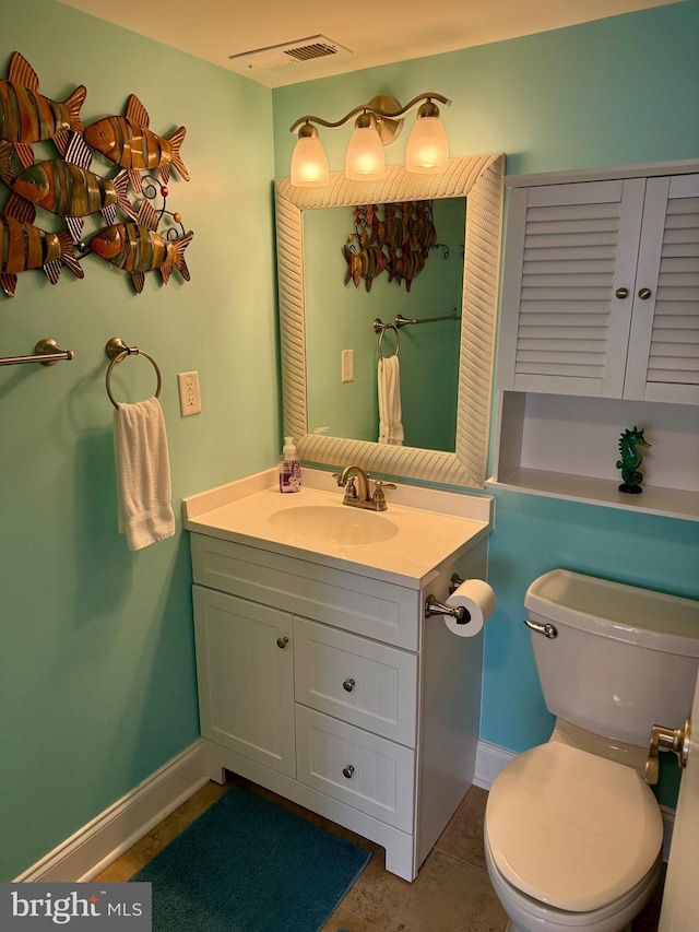 bathroom with tile patterned floors, vanity, and toilet