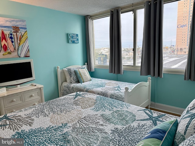 bedroom with multiple windows and a textured ceiling