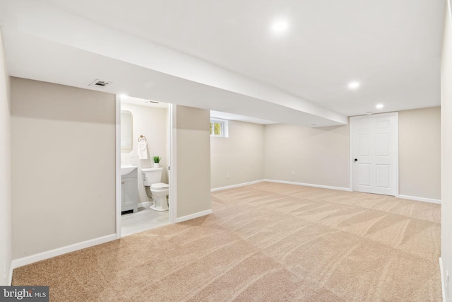 basement featuring light colored carpet