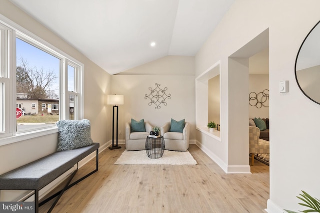 sitting room featuring light hardwood / wood-style flooring and lofted ceiling