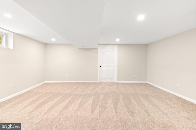 basement featuring light colored carpet