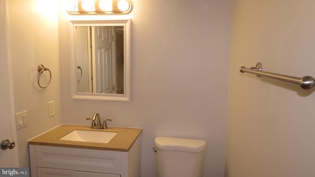 bathroom featuring toilet and vanity