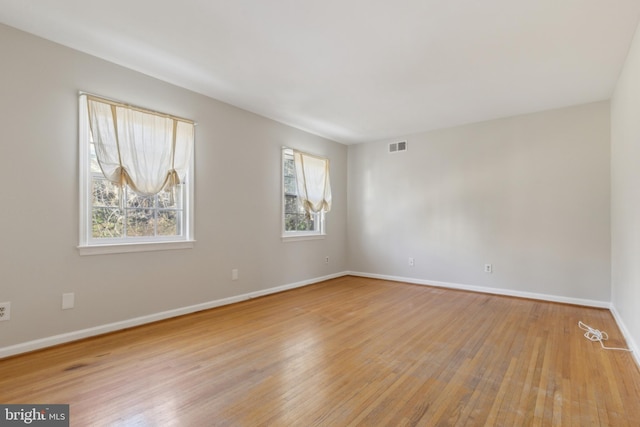 unfurnished room featuring light hardwood / wood-style floors