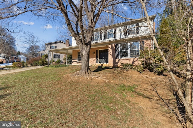 view of property featuring a front yard and a porch