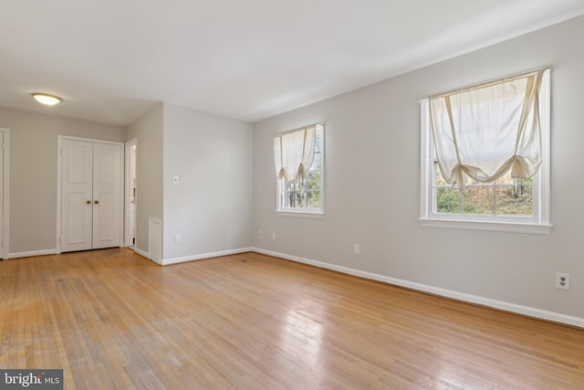 spare room with light wood-type flooring