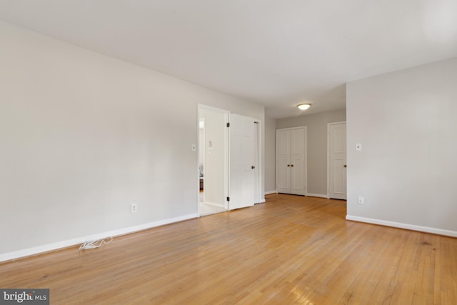 unfurnished room with light wood-type flooring