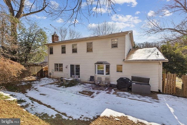 view of snow covered rear of property