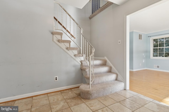 stairway featuring tile patterned flooring