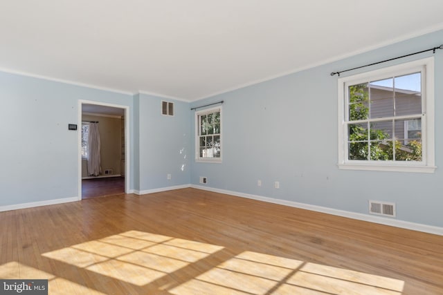 spare room with hardwood / wood-style flooring and ornamental molding