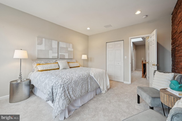 bedroom featuring a closet and light carpet