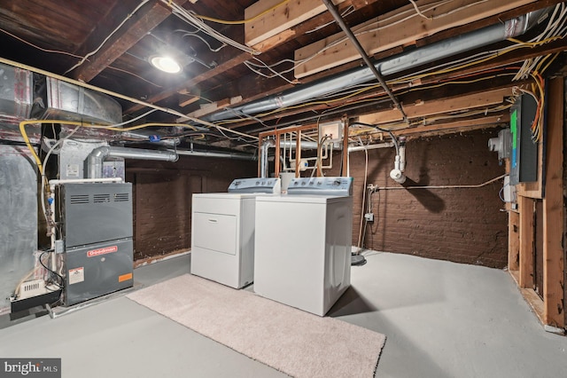 basement with heating unit and washing machine and clothes dryer