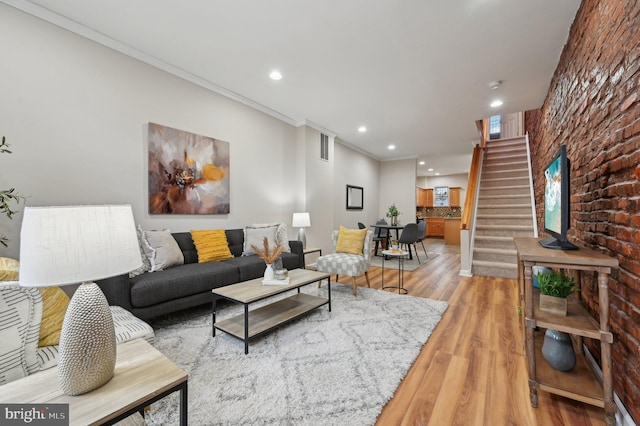 living room featuring crown molding and light hardwood / wood-style floors