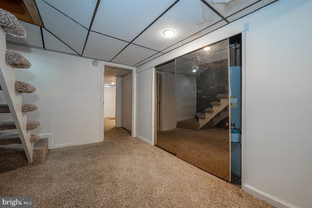 basement with carpet flooring and a drop ceiling