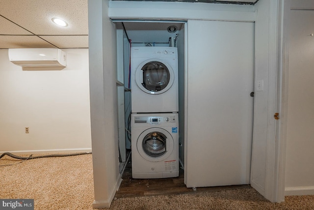 washroom with a wall mounted air conditioner, dark carpet, and stacked washer / drying machine