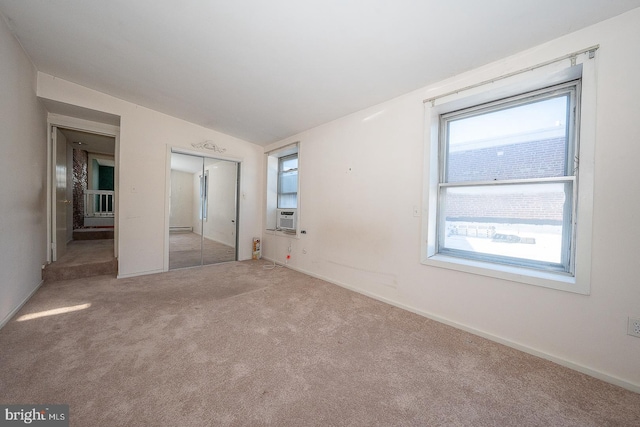 unfurnished bedroom with baseboard heating, light carpet, and lofted ceiling