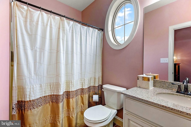 bathroom with toilet and vanity