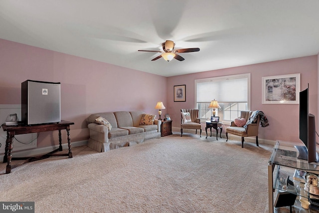 carpeted living room featuring ceiling fan