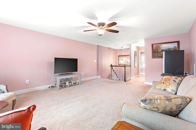 carpeted living room with ceiling fan