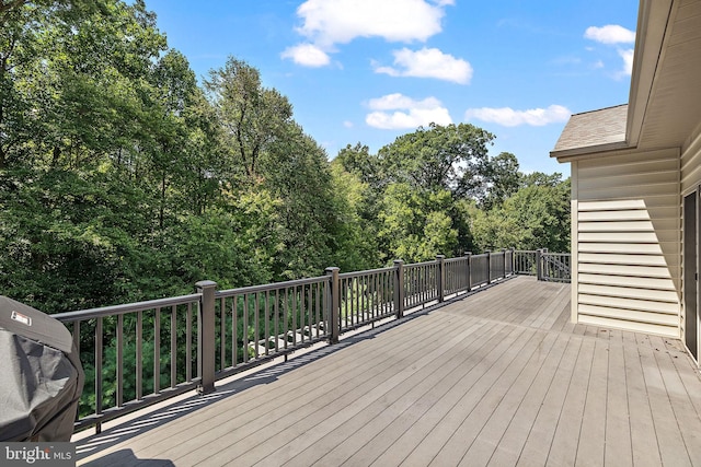 wooden terrace featuring a grill