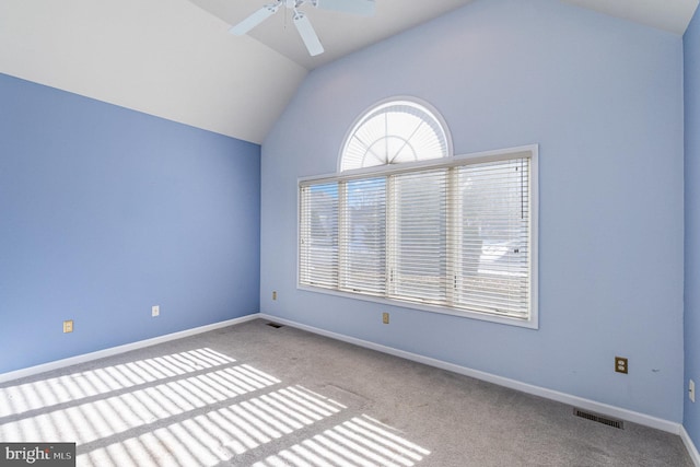 carpeted empty room with ceiling fan and vaulted ceiling