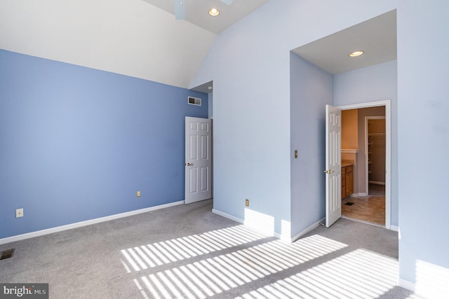 unfurnished bedroom with lofted ceiling and light colored carpet