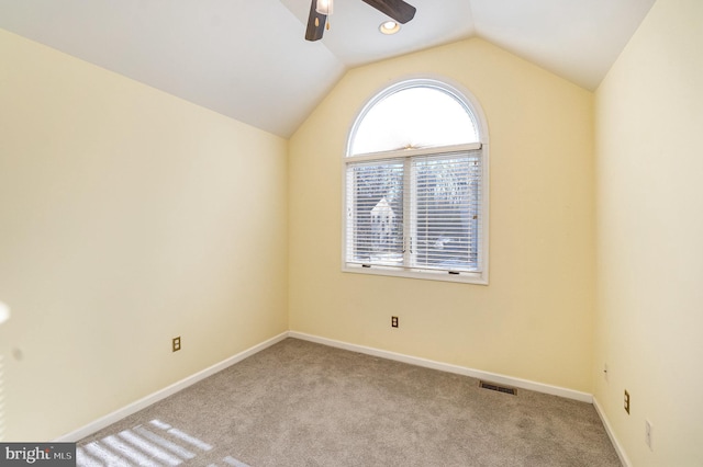 carpeted empty room with lofted ceiling and ceiling fan