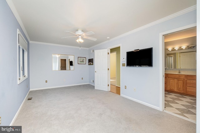 unfurnished bedroom featuring sink, connected bathroom, ceiling fan, crown molding, and light colored carpet