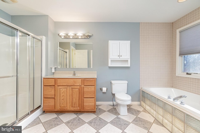 full bathroom featuring toilet, independent shower and bath, and vanity