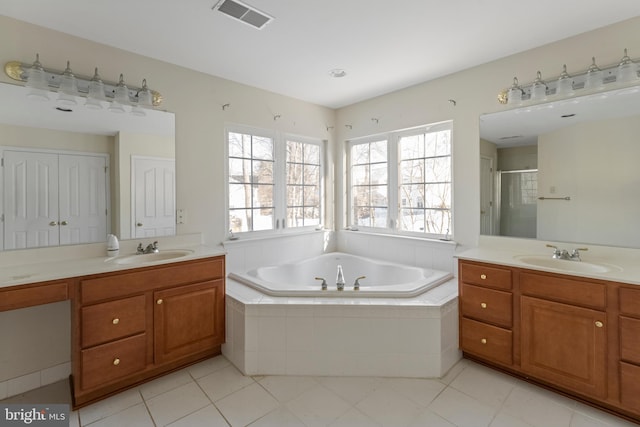 bathroom featuring plus walk in shower, tile patterned floors, and vanity